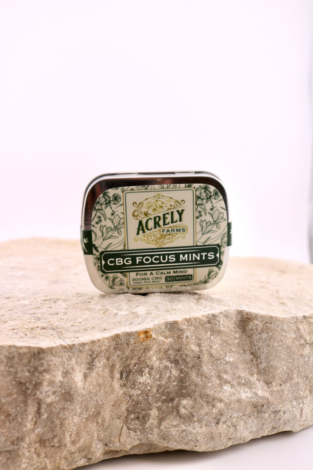 Acrely CBG Focus Mints tin on a stone surface with a white background