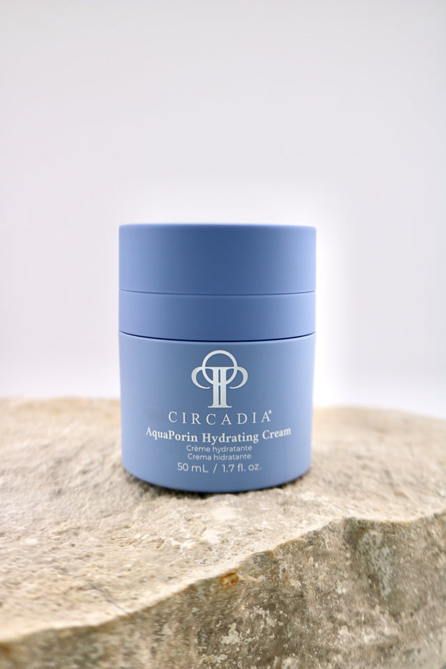 Circadia AquaPorin Hydrating Cream jar on a stone surface with a light gray background
