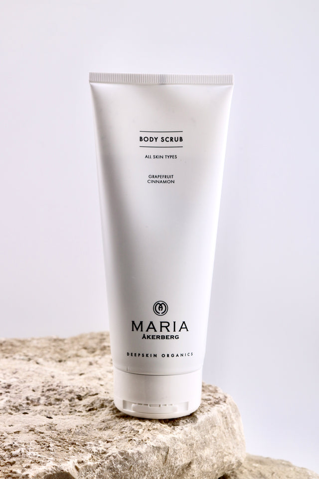 Body scrub tube with 'Maria Akerberg' branding on a light background