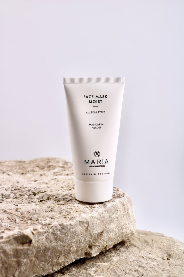 Tube of Maria face mask on a stone surface with a light gray background