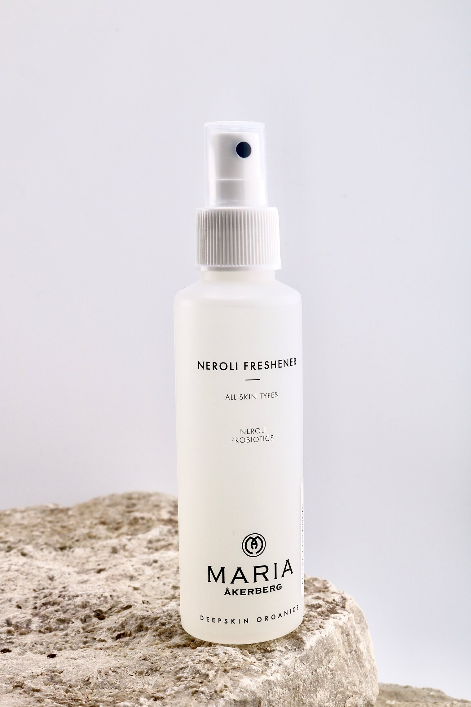 White spray bottle labeled 'Neroli Freshener' by Maria Akerberg on a textured surface with a light gray background.