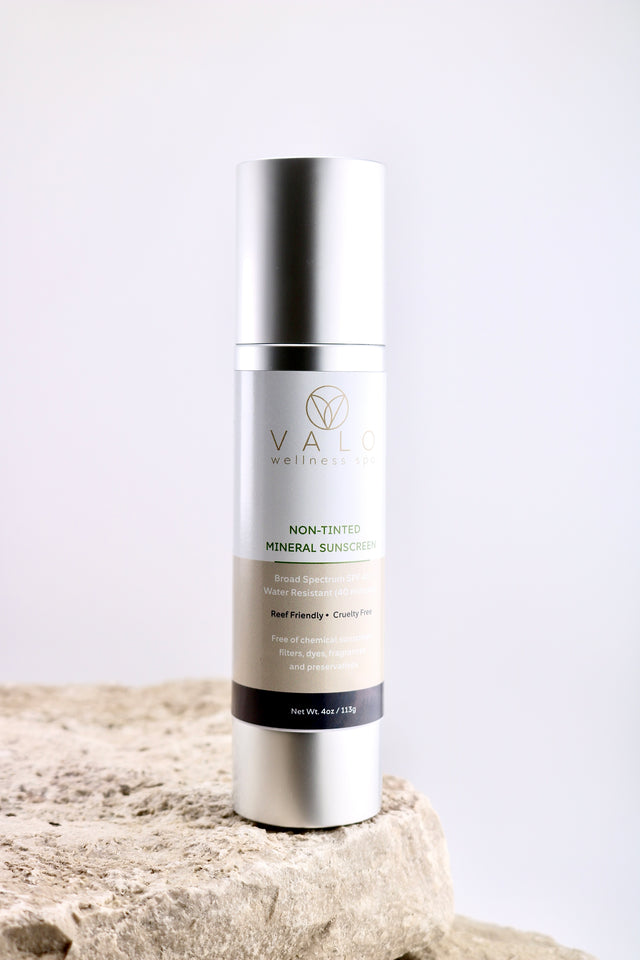 Skincare bottle on a textured surface with a light background