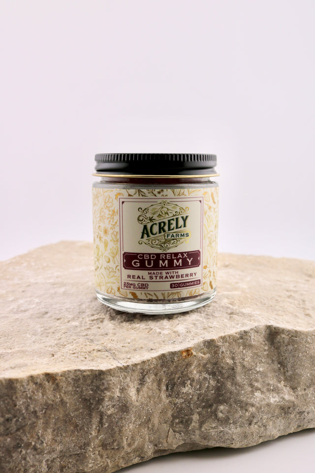 Jar of Acrely Farms CBD Relax Gummy on a stone surface with a white background