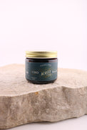 Bottle of CBD product on a stone surface with a white background