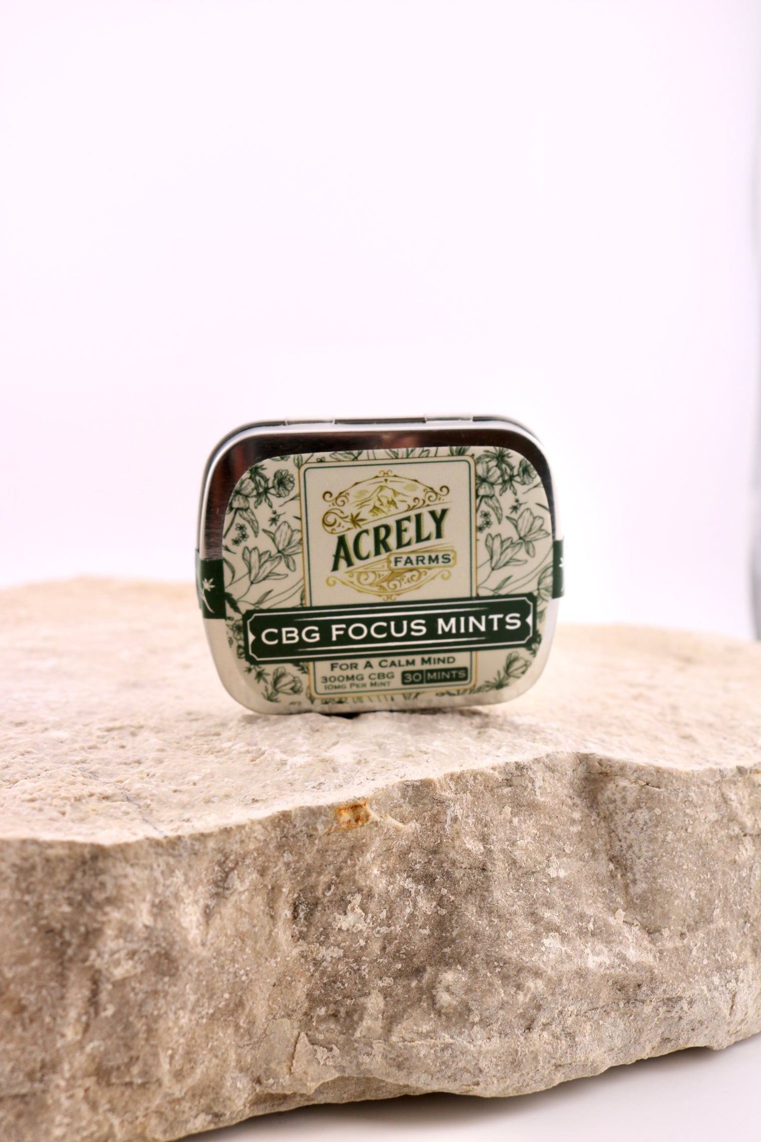 Acrely CBG Focus Mints tin on a stone surface with a white background
