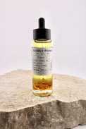 Bottle of Acrely Farms repair oil on a stone surface with a white background