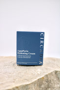 Circadia AquaPorin Hydrating Cream packaging on a stone surface with a light gray background