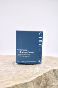 Circadia AquaPorin Hydrating Cream packaging on a stone surface with a light gray background