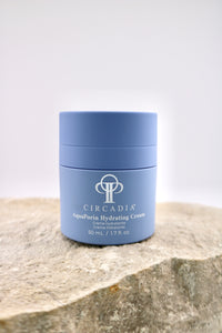 Circadia AquaPorin Hydrating Cream jar on a stone surface with a light gray background