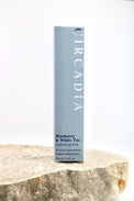 A tall rectangular box of Circadia Blueberry & White Tea Hydrating Mist stands upright on a rough stone slab against a clean white background.