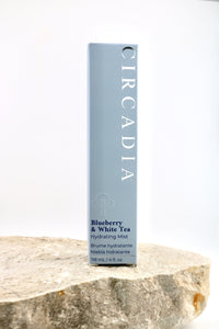 A tall rectangular box of Circadia Blueberry & White Tea Hydrating Mist stands upright on a rough stone slab against a clean white background.