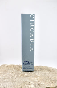 Circadia licorice and bearberry brightening mist packaging on a textured surface with a white background