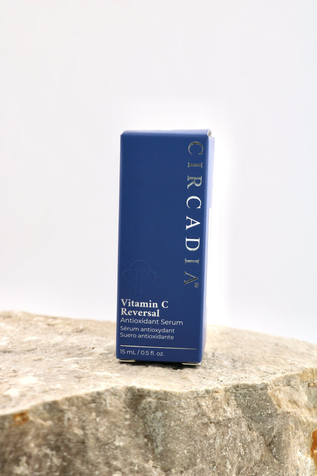 A blue rectangular box of Circadia Vitamin C Reversal Antioxidant Serum standing upright on a textured stone surface against a plain white background.