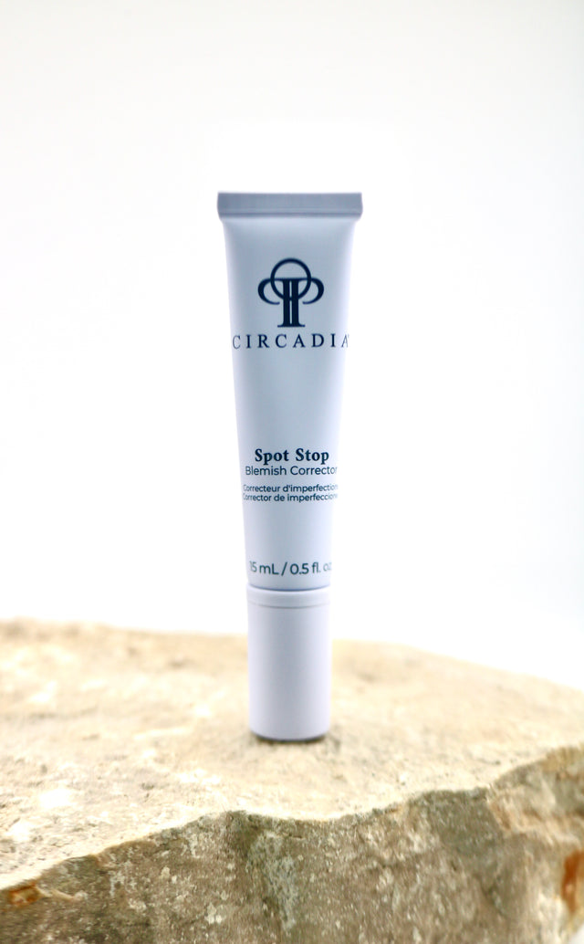Circadian Spot Stop Cream tube on a stone surface with a white background
