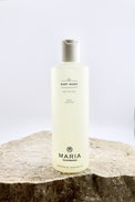 Bottle of Maria Åkerberg baby wash on a stone surface with a light background