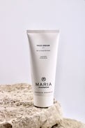 Tube of 'Face Dream' cream by Maria Akerberg on a stone surface with a light gray background