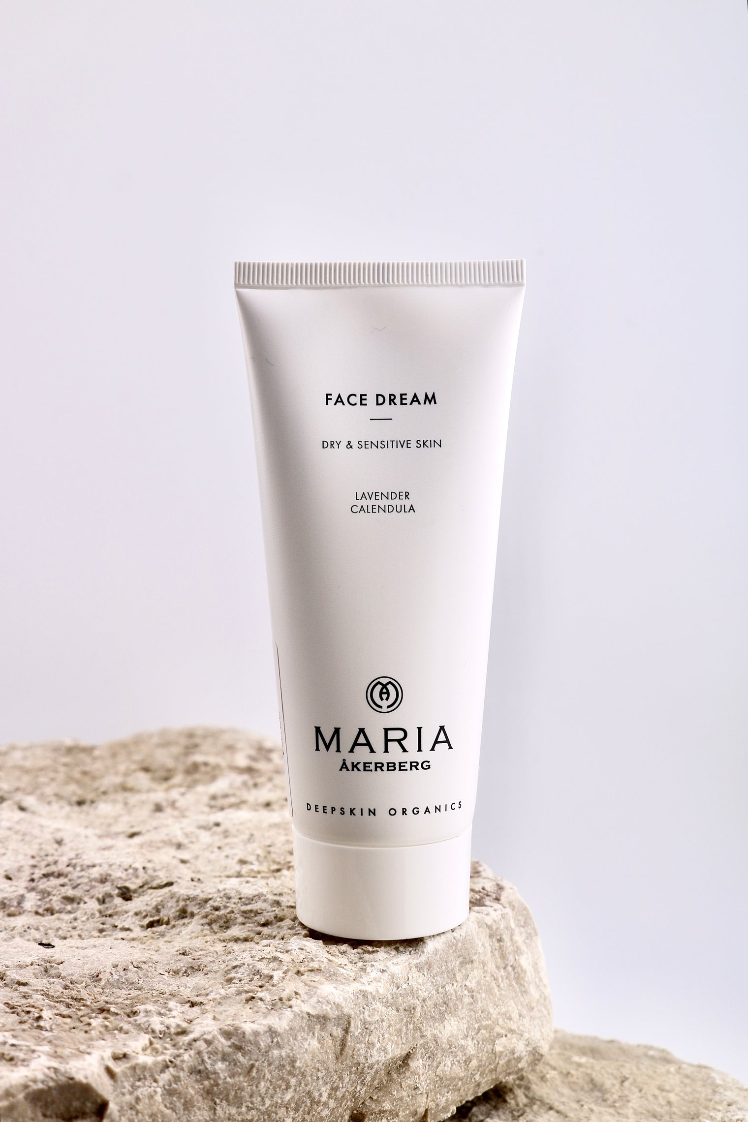 Tube of 'Face Dream' cream by Maria Akerberg on a stone surface with a light gray background