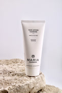Tube of Maria Åkerberg face lotion on a rock with a light gray background