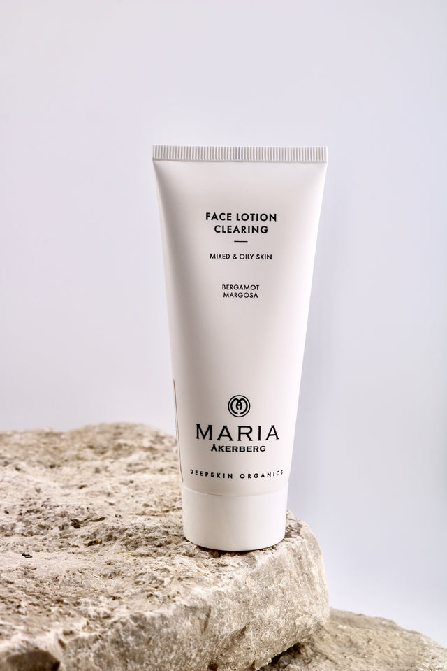 Tube of Maria Åkerberg face lotion on a rock with a light gray background