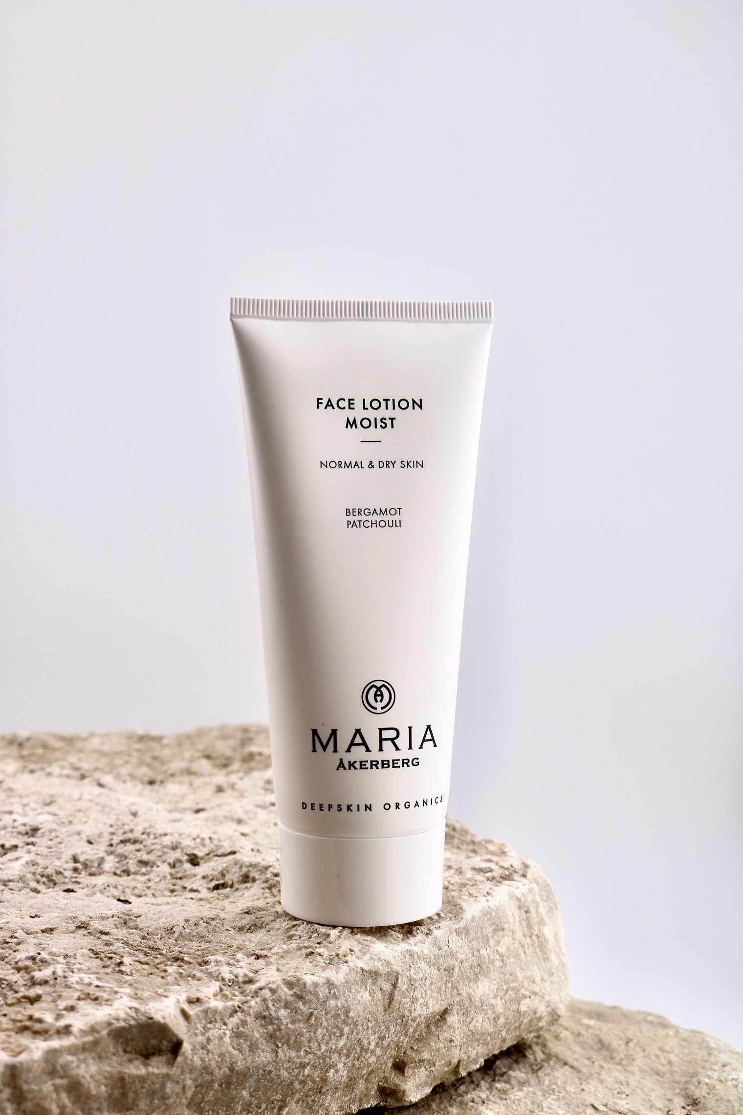 Tube of Maria Åkerberg Face Lotion Moist on a stone surface with a light gray background