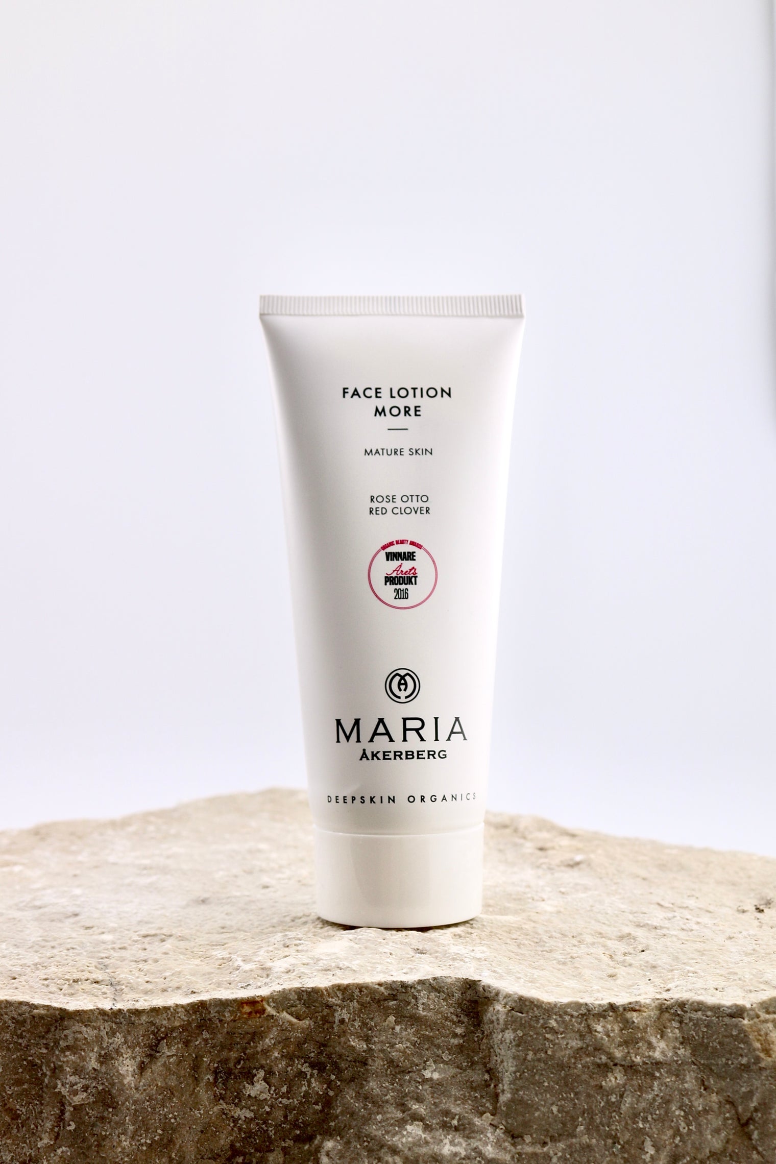 Tube of Maria Åkerberg face lotion on a stone surface with a white background