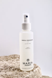 White spray bottle labeled 'Neroli Freshener' by Maria Akerberg on a textured surface with a light gray background.