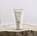 Tube of Maria Åkerberg night cream on a stone surface with a light gray background