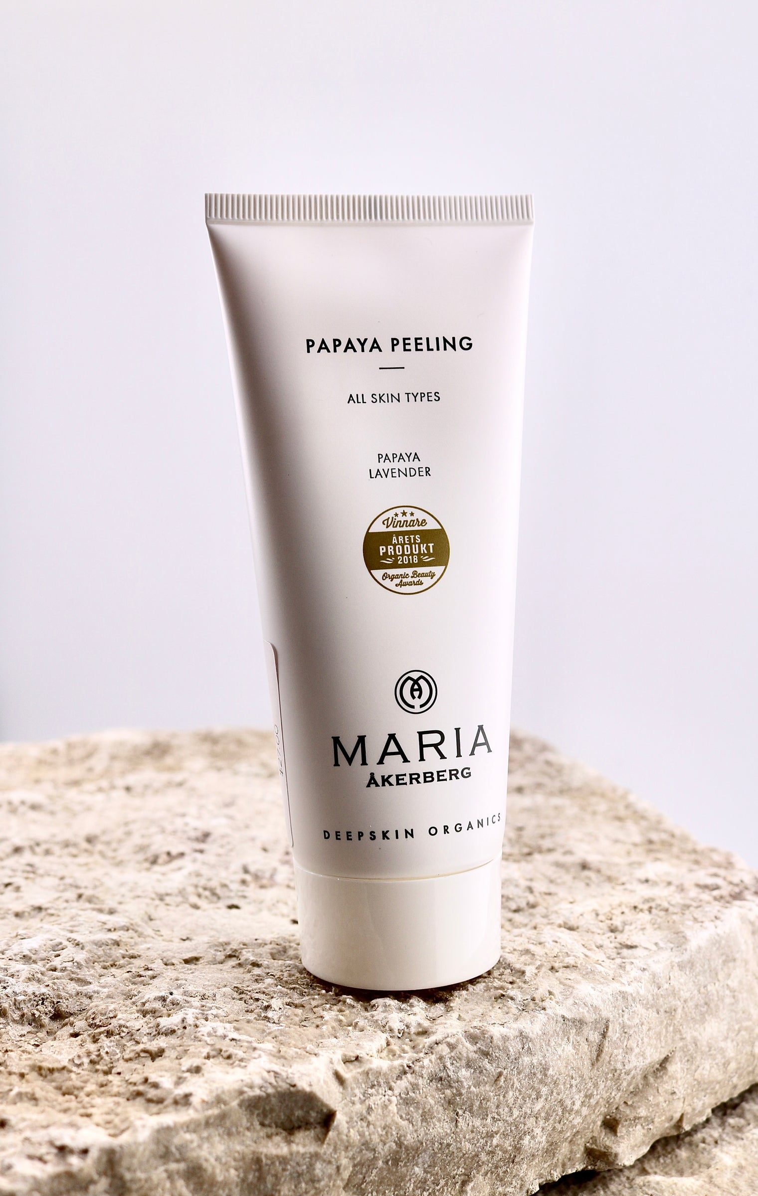 Tube of Maria Akerberg Papaya Peeling on a stone surface with a light background