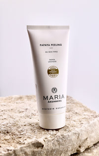 Tube of Maria Akerberg Papaya Peeling on a stone surface with a light background