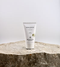 Tube of Maria Papaya Peeling on a stone surface with a light gray background