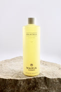 Bottle of Maria Åkerberg shea butter oil on a stone surface with a white background