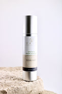 Skincare bottle on a textured surface with a light background