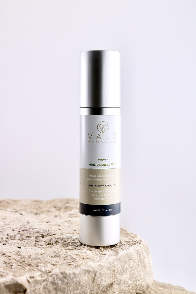 Skincare bottle labeled 'Viva' on a textured surface with a light background